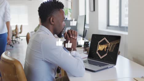 Animación-De-íconos-De-Pulgar-Hacia-Arriba-Sobre-Un-Hombre-Afroamericano-Mirando-El-ícono-De-Texto-Nft-En-Una-Computadora-Portátil