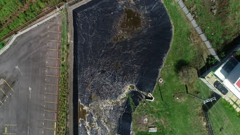 ,wastewater treatment plant, waterless retention pond in residential, aerial view, aerial video, parking