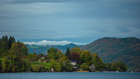 quaint homes overlook lake attersee austria as clouds rush by mountains