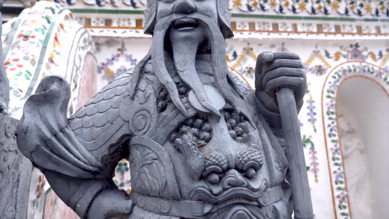 Slow motion shot bottom up of a statue at Wat Pho temple in Thailand. Stunning temple complex with close-ups of intricate details. Perfect for travel, cultural, and religious themed projects.