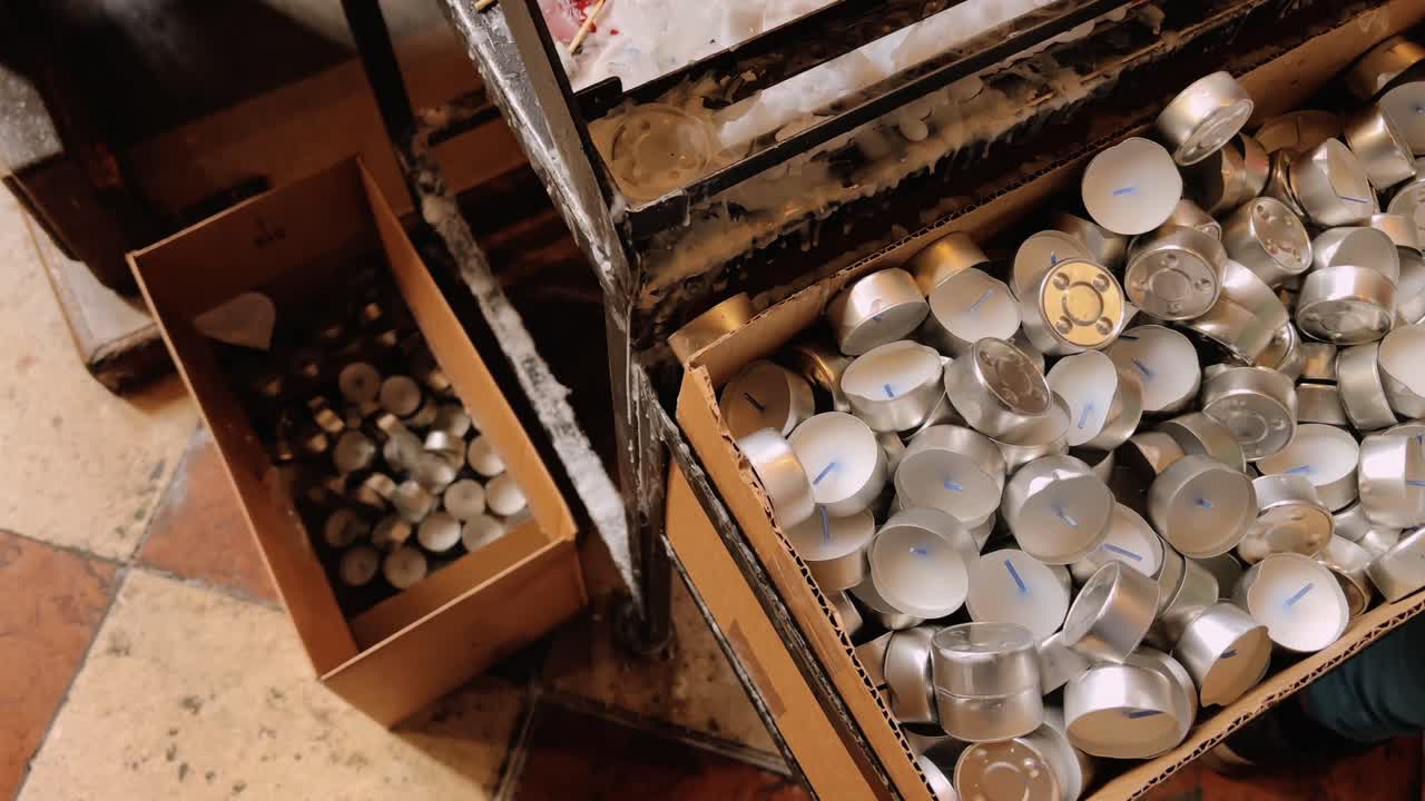 candles in boxes on storage shelf