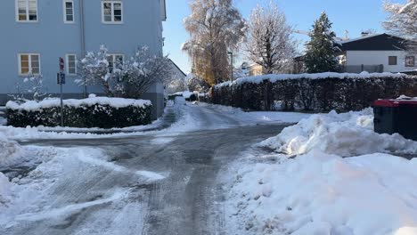 snow covered streets in generic german austrian european street, panning, day