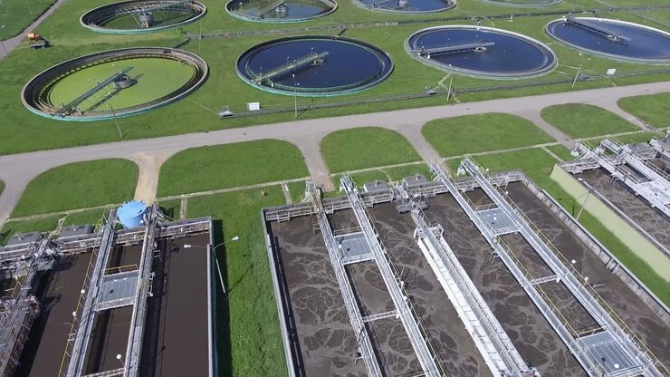 Sewage farm. Static aerial photo looking down onto the clarifying tanks and green grass.