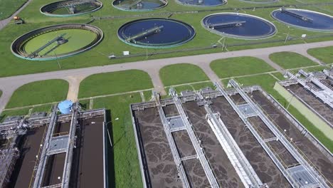 sewage farm. static aerial photo looking down onto the clarifying tanks and green grass.