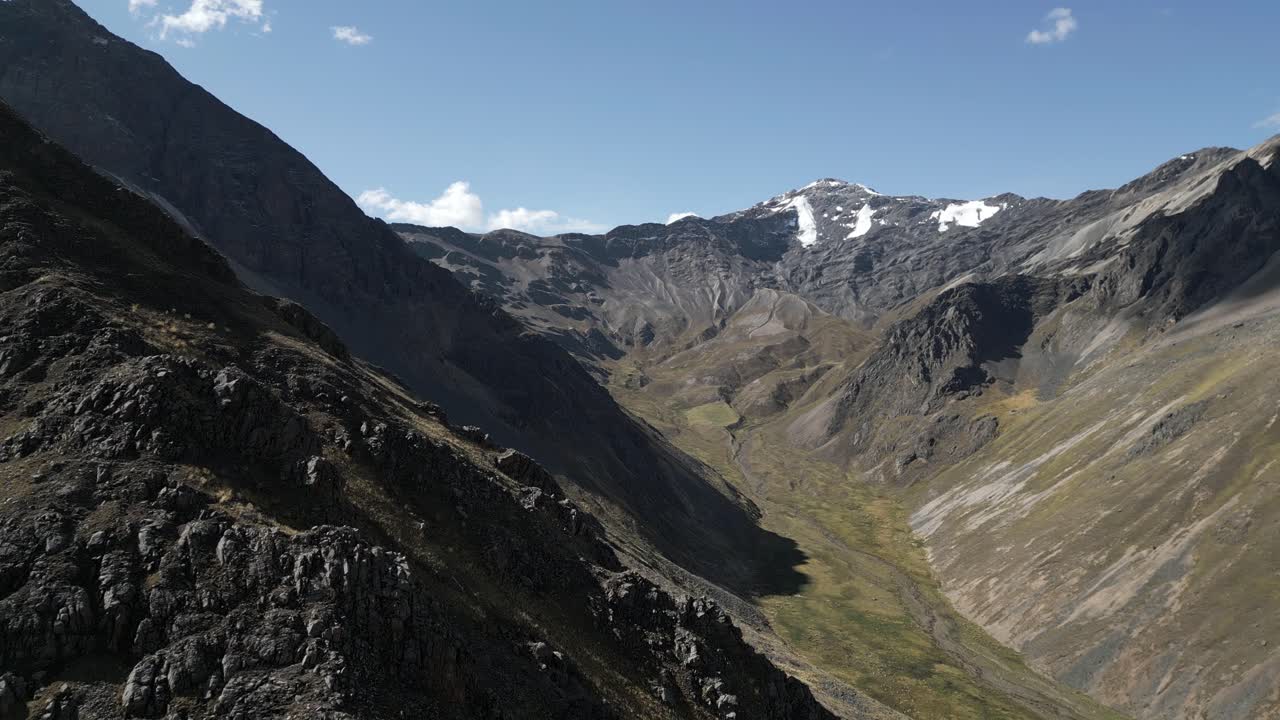 Aerial reveal of spectacular rocky summits, Peruvian Andes mountain tops