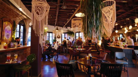lively bar interior with people and modern bohemian decor