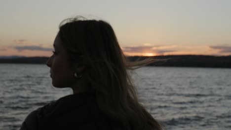 Woman-On-Vacation-Enjoying-The-View-Of-A-Sunset-Beach