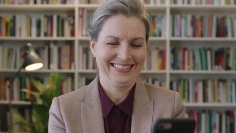 portrait-of-mature-business-woman-executive-smiling-enjoying-texting-browsing-using-smartphone-mobile-app-professional-female-networking