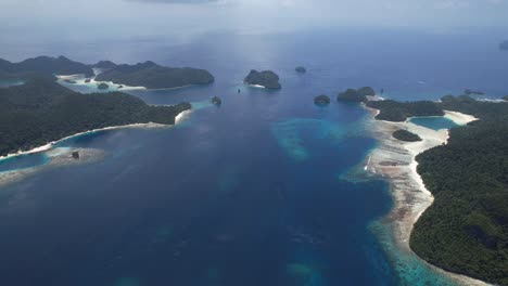 high altitude stunning view on many islands, white sandy beaches, lush green flora, coral reefs in raja ampat, wayag, indonesia, papua