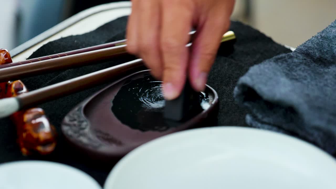 Footage of a Japanese Man Painting a Nihonga, a Traditional Japanese Painting, with Brushes and Black Ink