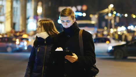 a young couple uses a tablet for directions 1