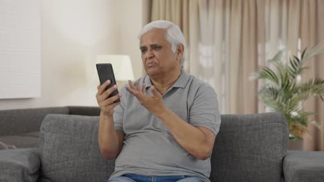 Indian-old-man-talking-on-video-call