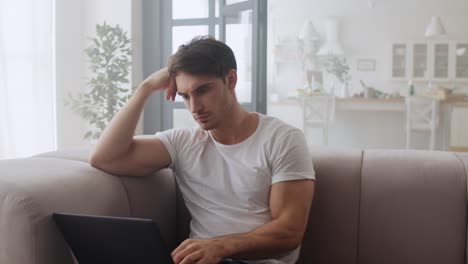 Focused-businessman-using-laptop-computer-at-home-office-in-slow-motion.