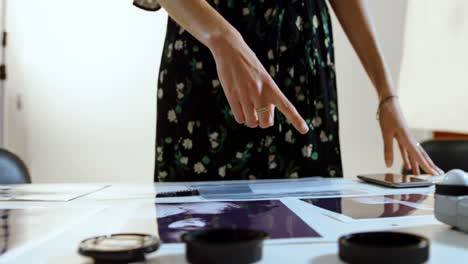 female photographer looking photos on desk 4k