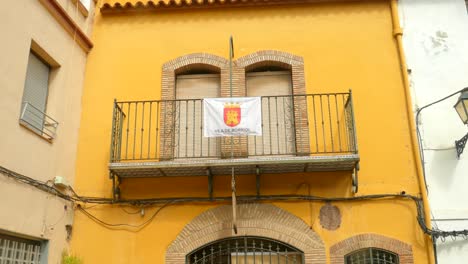 front exterior facade of an old typical spanish building in a quaint village of borriol, spain