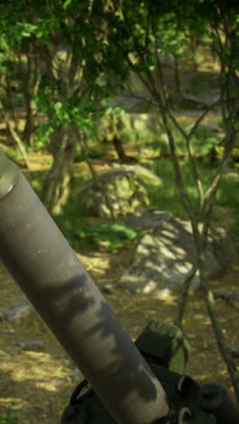 Weapon system camouflaged in dense forest setting during daytime