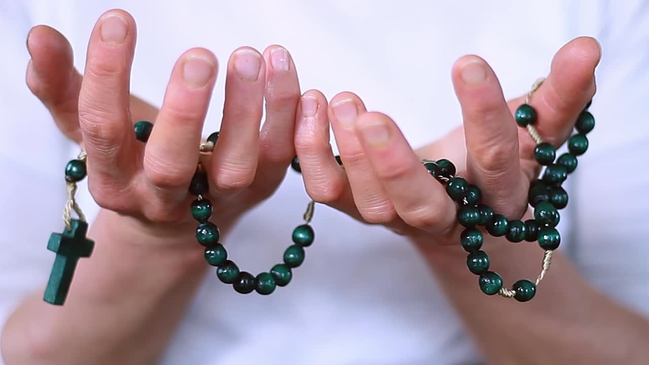 Vídeos de stock con manos rezando y crucifijo con cruz y personas