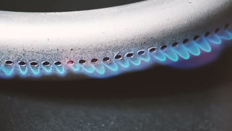 burning gas burner in the oven close-up on a black background. 4k macro raw video.