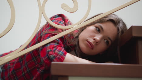 young woman sitting on the stairs, looking sad