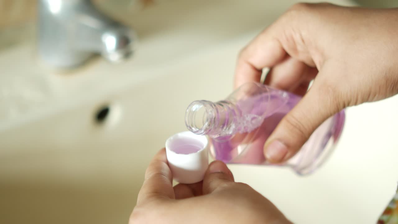 Pouring Mouthwash