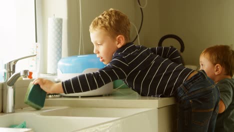 Siblings-cleaning-kitchen-sink-4k