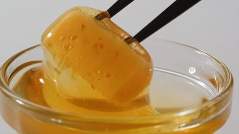 honey in a glass bowl with tools