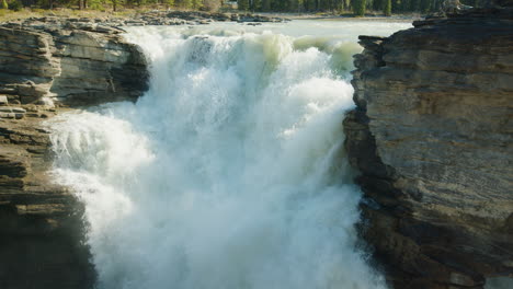 Athabasca-River-Cascading-Down-in-Immense-Waterfall,-Sunny-Day