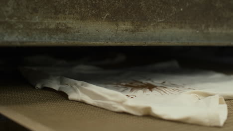 shirts passing through dryer after screen printing