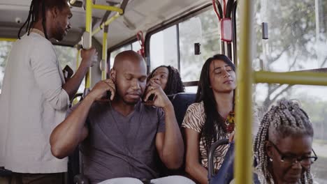 People commuting on a bus, with passengers listening to music and relaxing during their journey