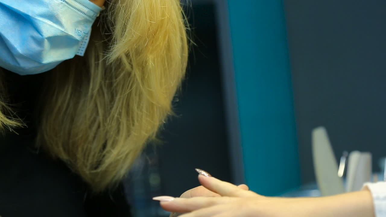 Woman hands in a nail salon receiving a manicure