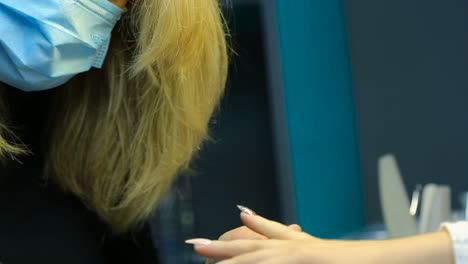 woman hands in a nail salon receiving a manicure