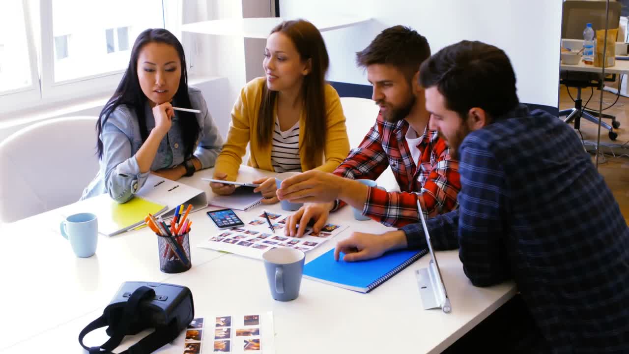 Graphic designers discussing over photographs