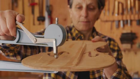 female luthier at work in her workshop