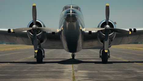 vintage twin-engine propeller airplane on a runway