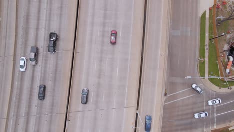 Aerial-view-above-traffic-on-a-interstate,-in-Texas,-USA---rotating,-birds-eye,-drone-shot