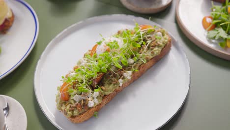 delicious avocado toast with poached egg and microgreens