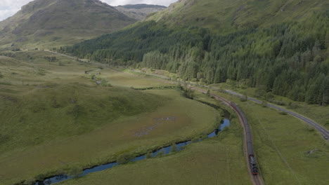 jacobite express aerial orbital tracking shot towards glenfinnan station