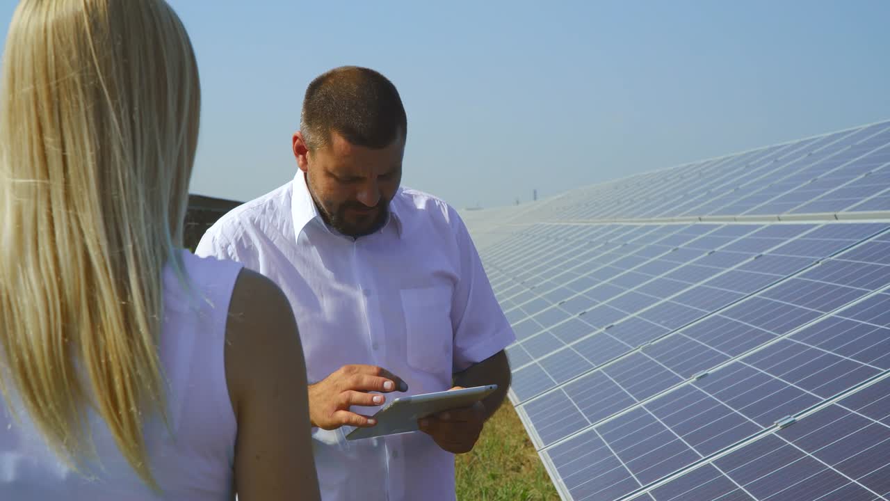 Man and woman talking at solar power plant
