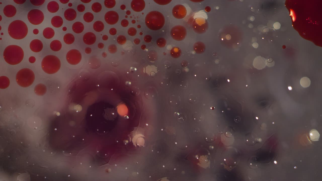 Macro abstract red and clear liquid bubbles motion together texture background