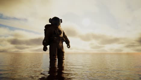 spaceman in the sea under clouds at sunset