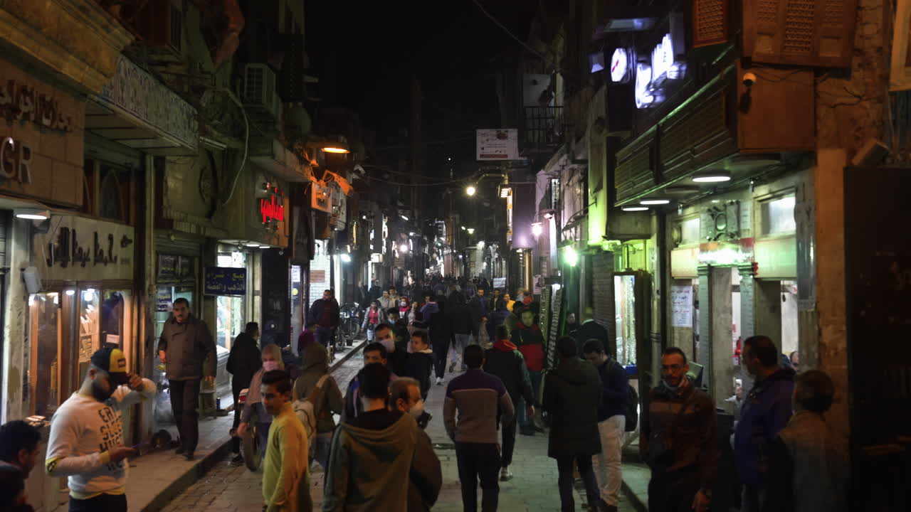 People Walking Through Famous Khan el-Khalili Bazaar And Souq At Night In  Cairo, Egypt.