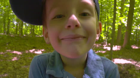 Outdoor-portrait-of-a-smiling-little-boy-missing-his-front-teeth