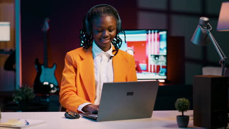 African-american-pupil-resolving-project-tasks-with-music-on-her-headphones