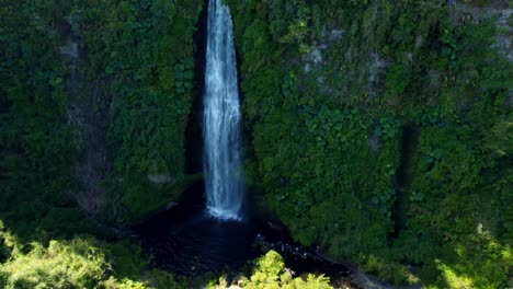 Aerial-orbit-of-the-Tocoihue-waterfall-on-the-Big-Island-of-Chiloe-in-southern-Chile,-group-of-people-taking-pictures