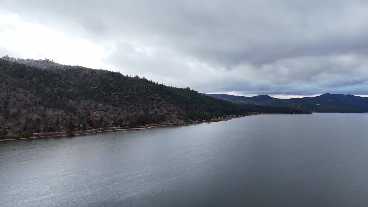 Slow-moving clouds drift above Big Bear Lake and surrounding peaks