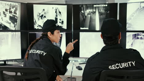 security guards monitor security cameras in a control room