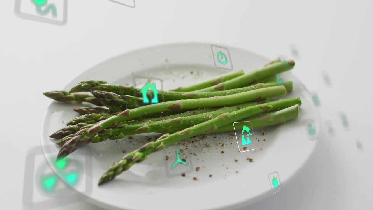 After pause green asparagus on plate undergoing icon appearing and orbiting to highlight eco food