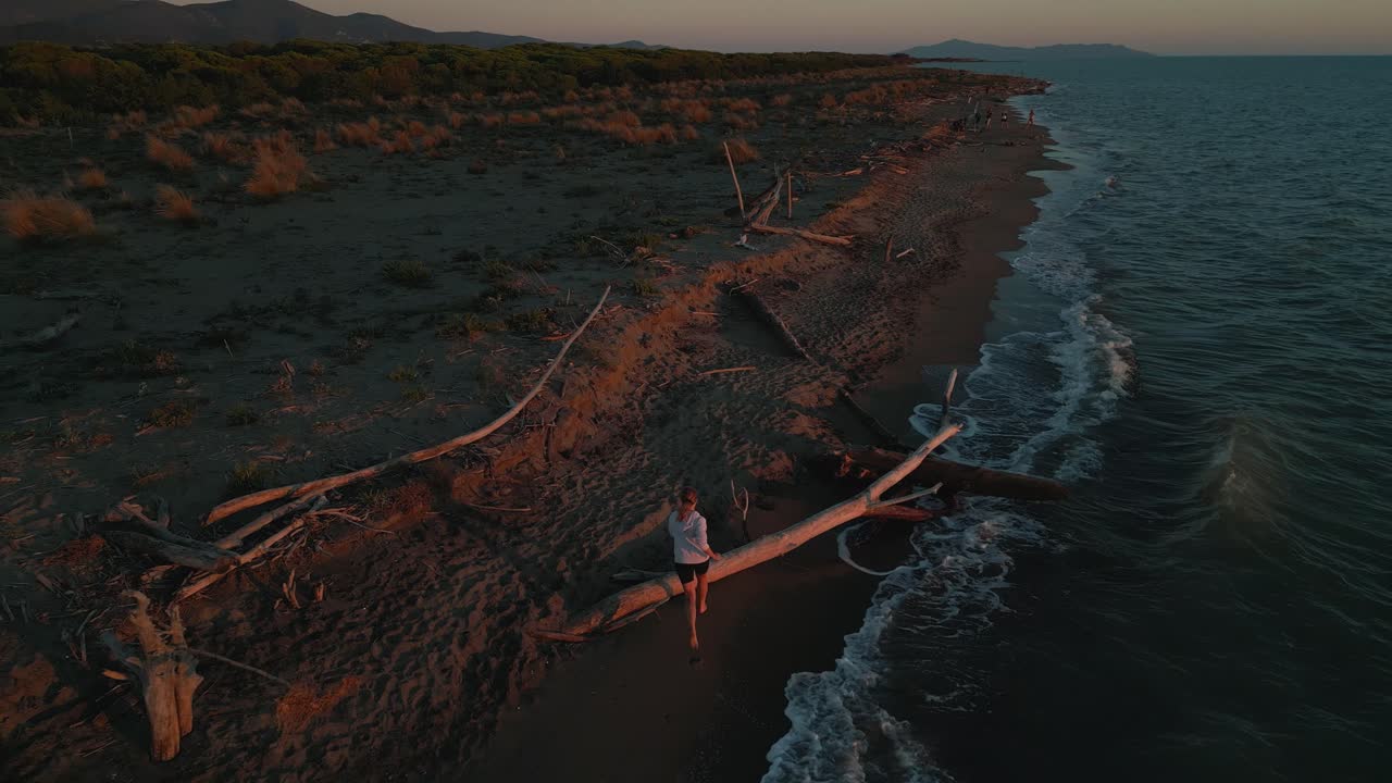 One young woman running jogging at a sandy beach sea at sunset doing active sport fitness training for marathon and triathlon and a healthy body, muscles and endurance