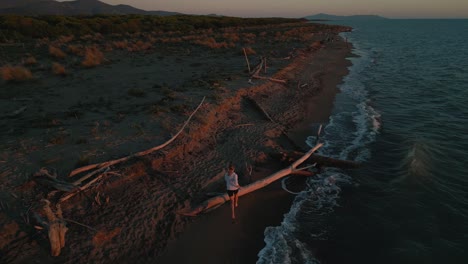 one young woman running jogging at a sandy beach sea at sunset doing active sport fitness training for marathon and triathlon and a healthy body, muscles and endurance