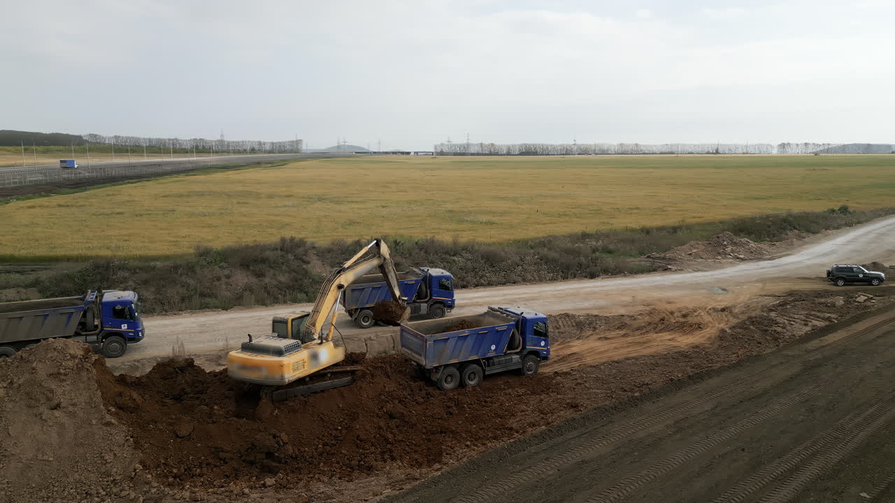 Highway Road Construction Site with Excavators and Dump Trucks
